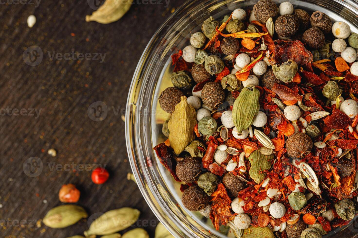 Turmeric powder in glass bowl on wooden table close up photo