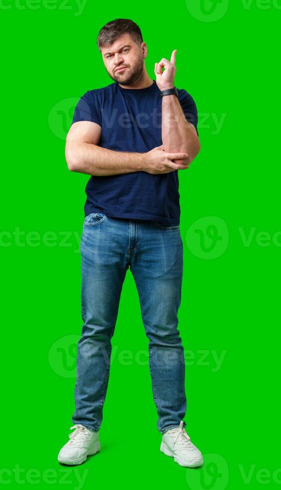 A man thoughtfully ponders on a bright green background photo