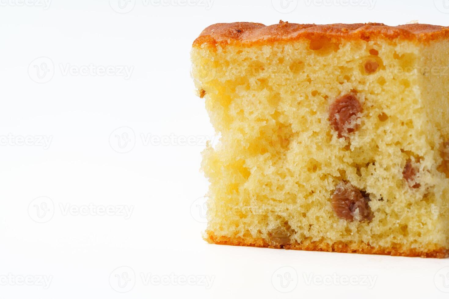 Moist cake slice with raisins displayed against a plain white background during a casual baking event photo