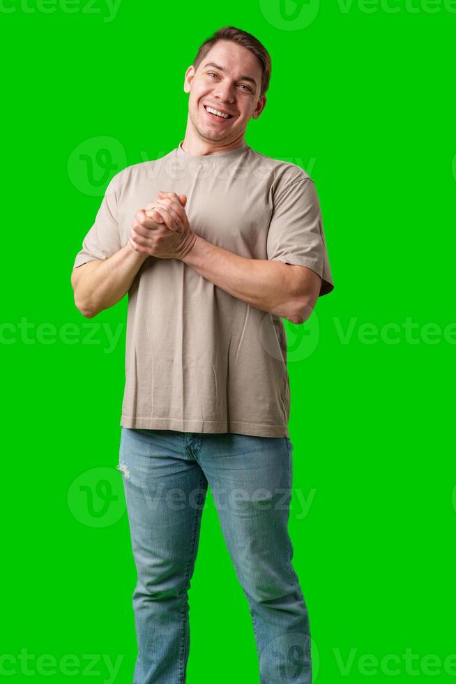 A cheerful man with a friendly smile poses against a bright green background photo