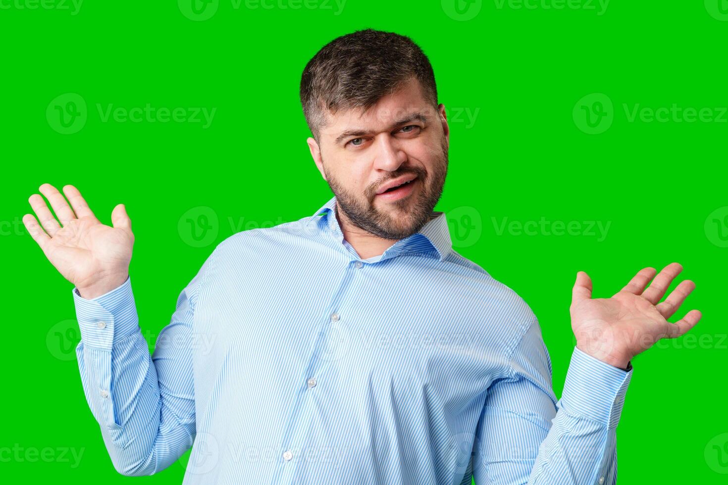A man playfully posing with a quirky expression against a bright green background photo