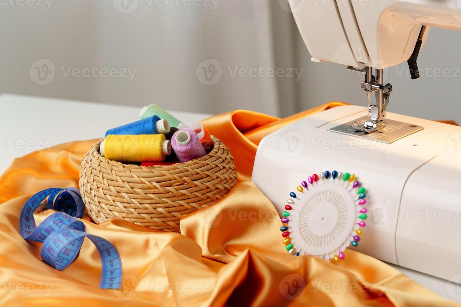 Sewing machine in use on a wooden table, stitching a light fabric in a well-lit indoor workspace photo