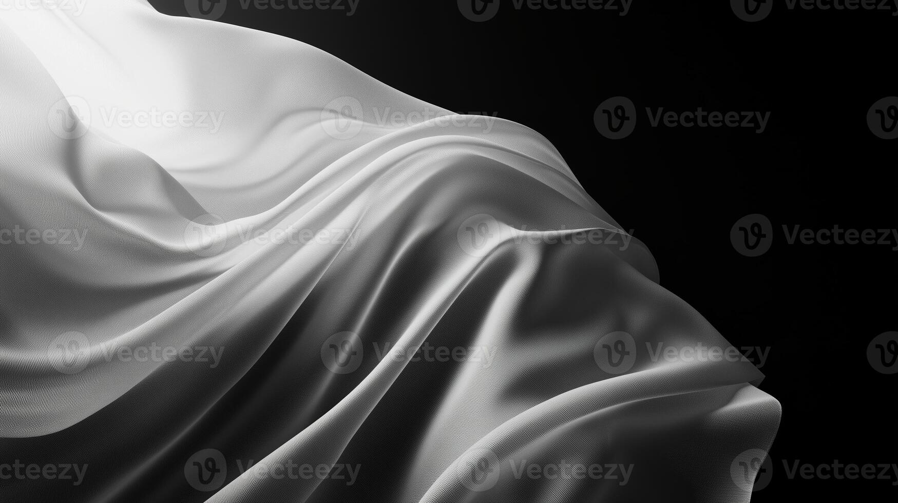 Elegant white fabric draped gracefully against a dark background showcasing soft folds and contours photo