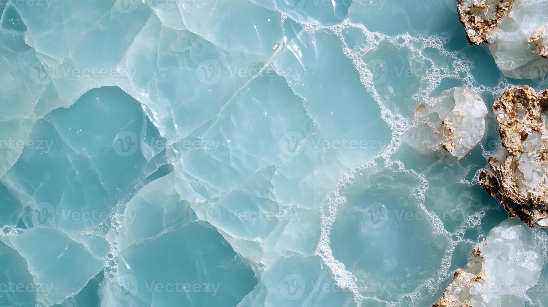 Turquoise water texture with crystalline rocks along the shore in a sunny coastal location photo