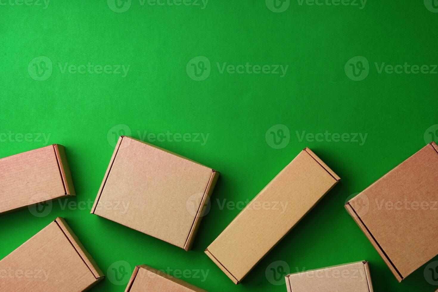 Brown cardboard boxes arranged on a vibrant green surface photo