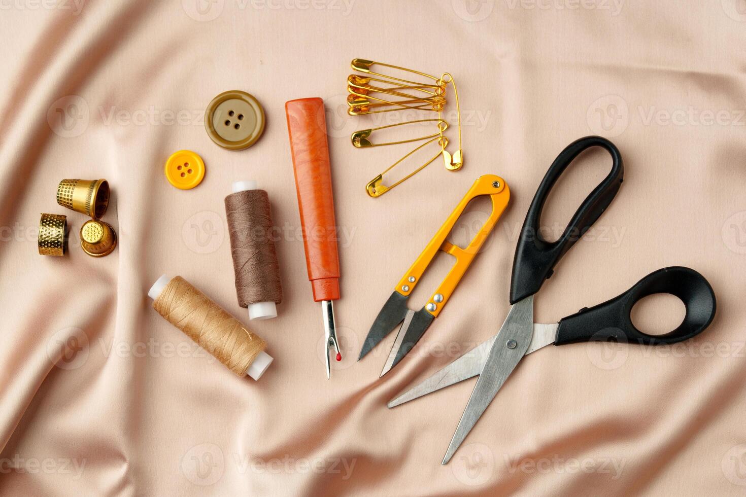 Sewing tools and materials arranged on soft fabric showcasing essential crafting supplies for creative projects photo