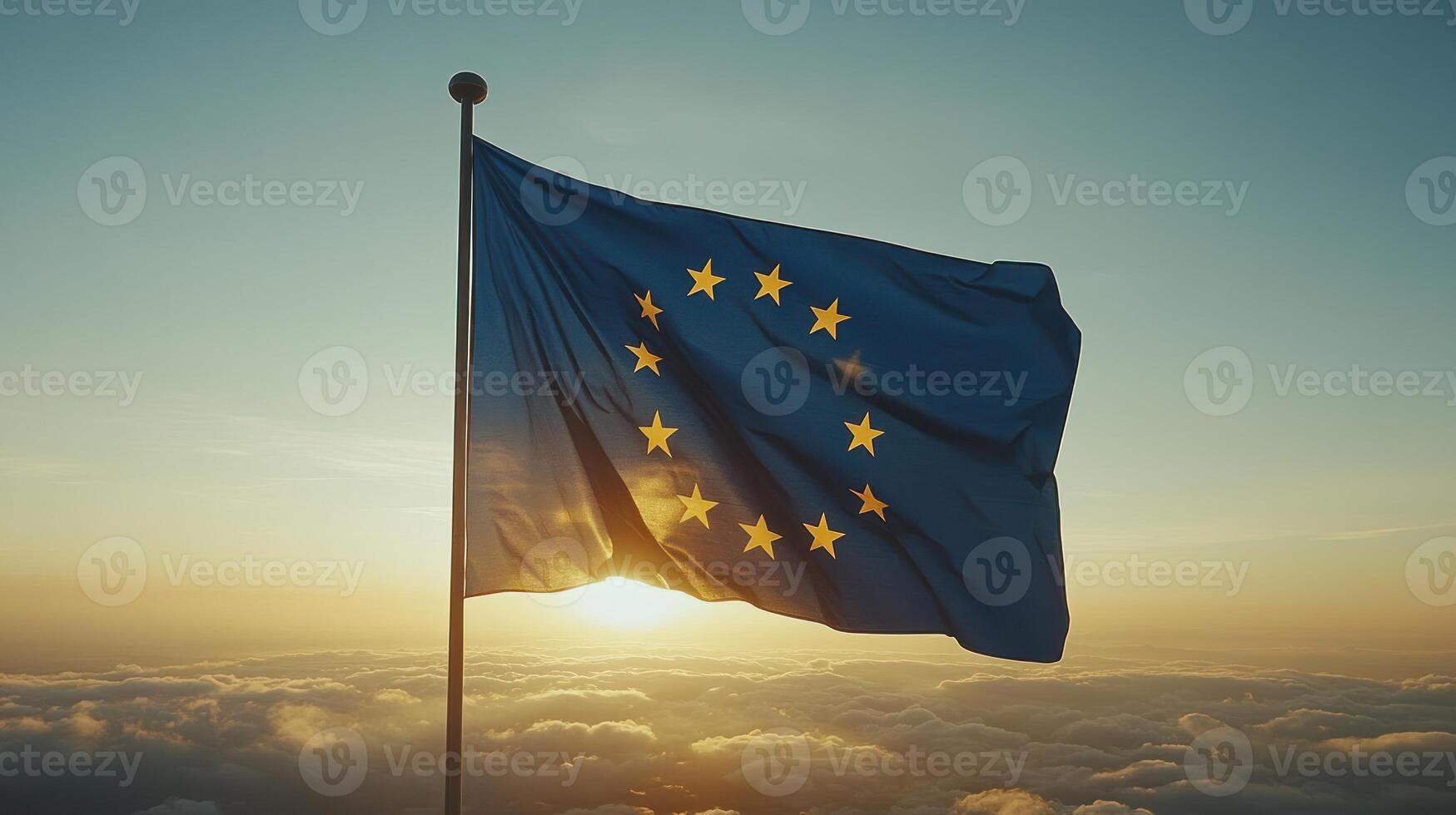 A flag representing Europe flutters in the wind during sunrise, casting a hopeful glow over the clouds photo