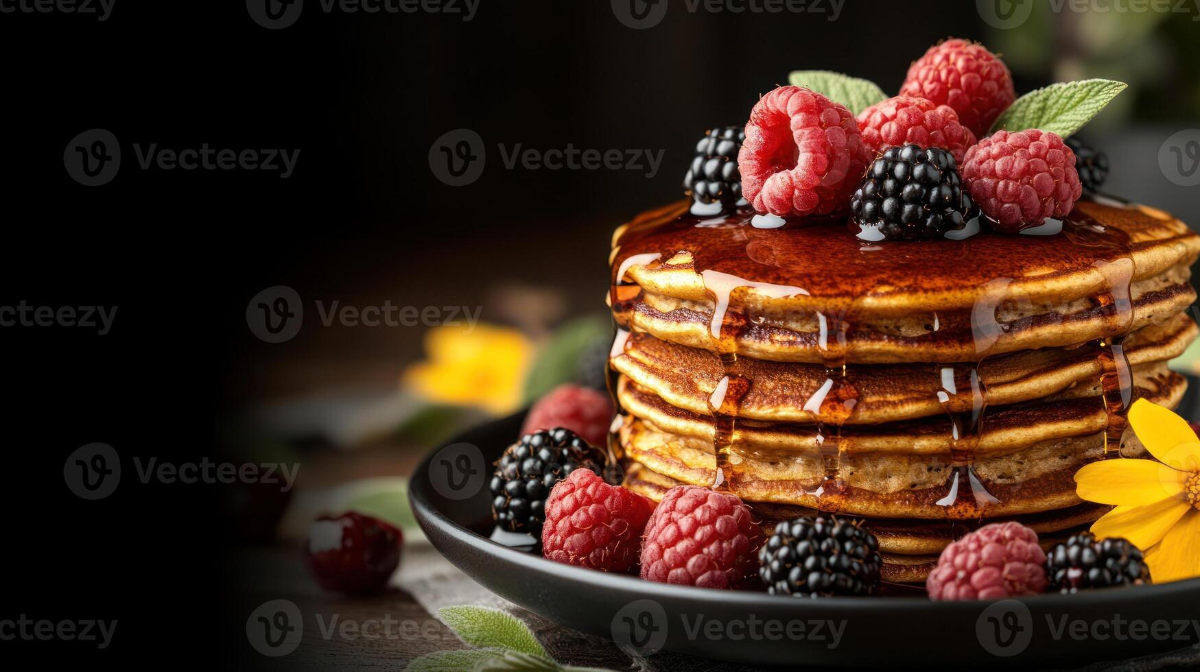 A tasty stack of pancakes topped with berries and syrup makes for a delightful breakfast photo