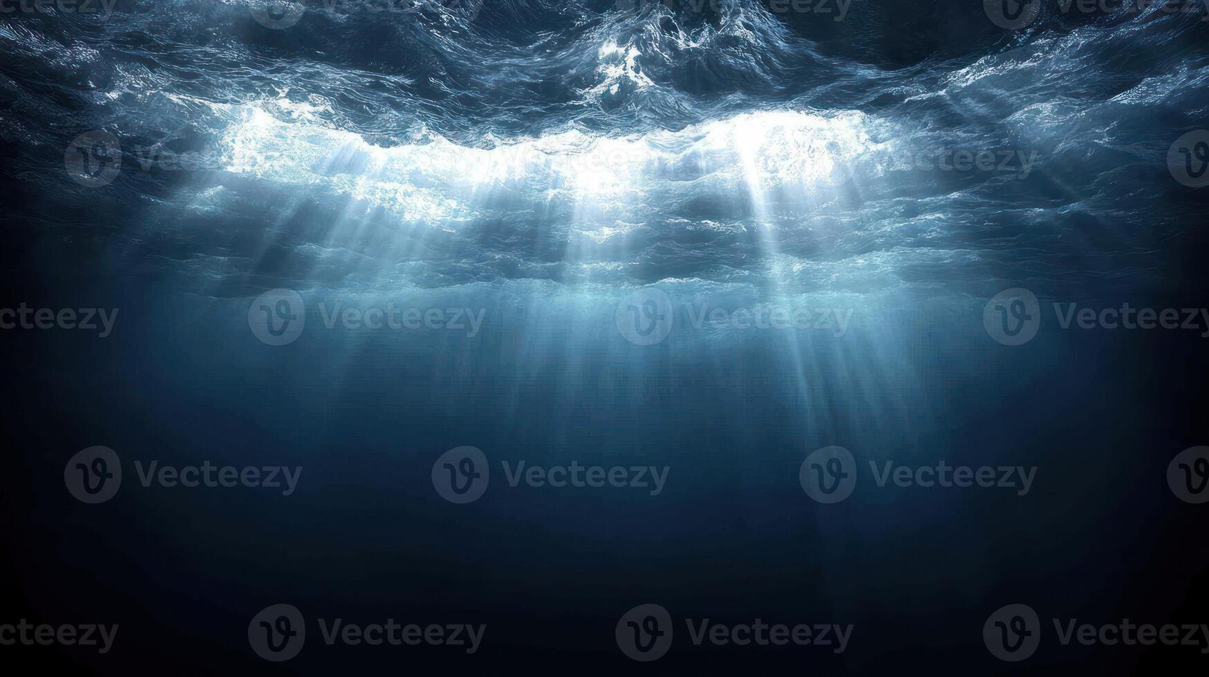 Sunlight pierces the ocean, casting tranquil tones in the deep blue waters below photo