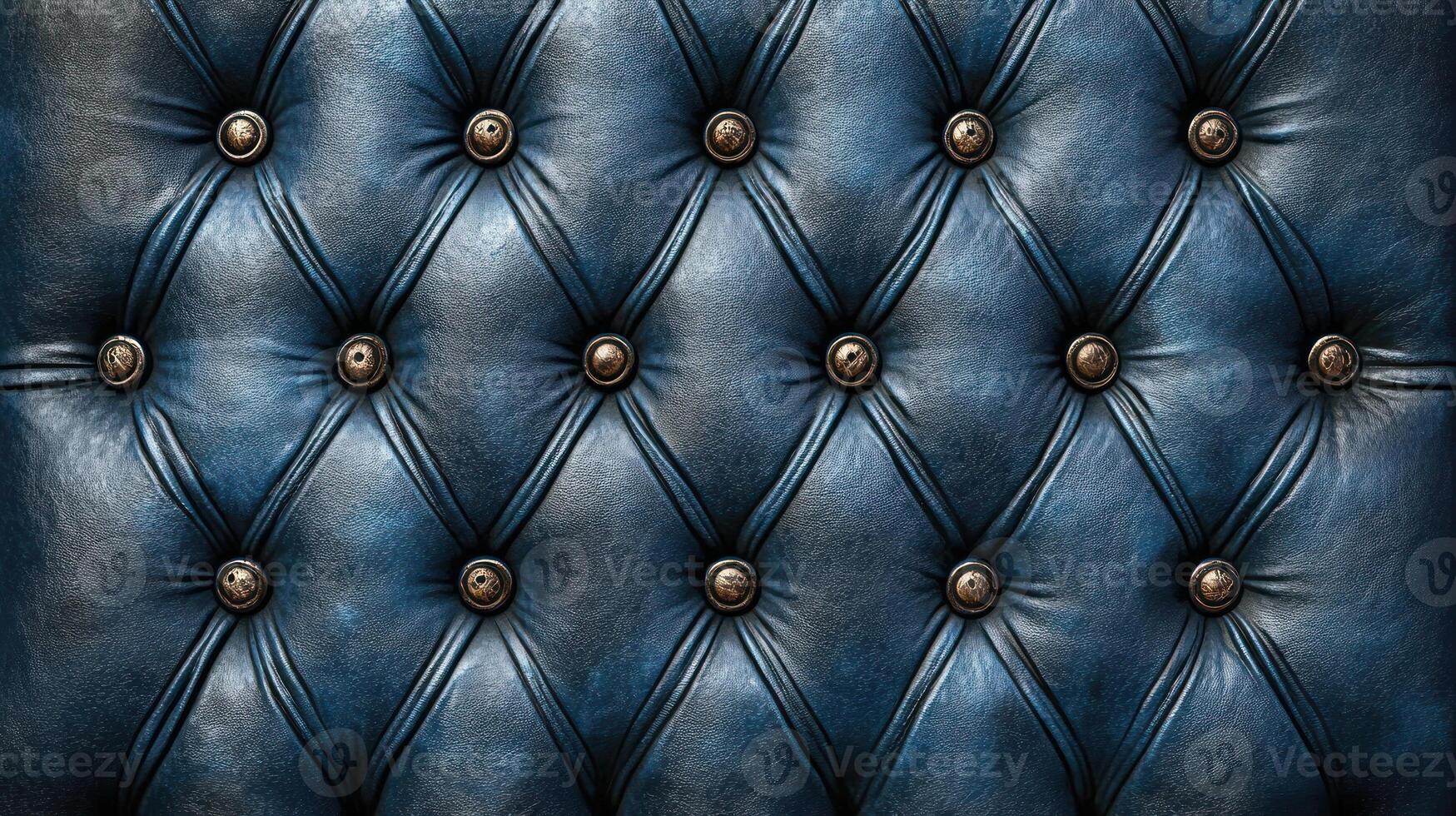 Detailed texture of deep blue leather upholstery showcases tufting and metal buttons for a stylish look photo