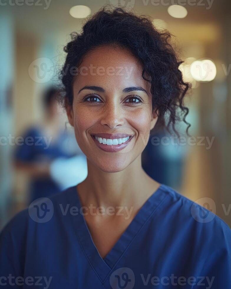A healthcare worker smiles warmly while attending to patients in a medical environment photo