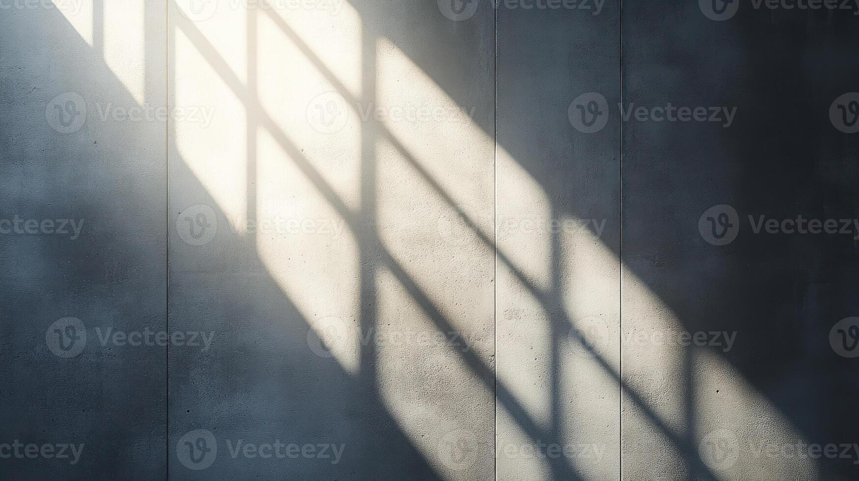 Sunlight creates a pattern of shadows on a simple concrete wall showcasing texture and depth photo