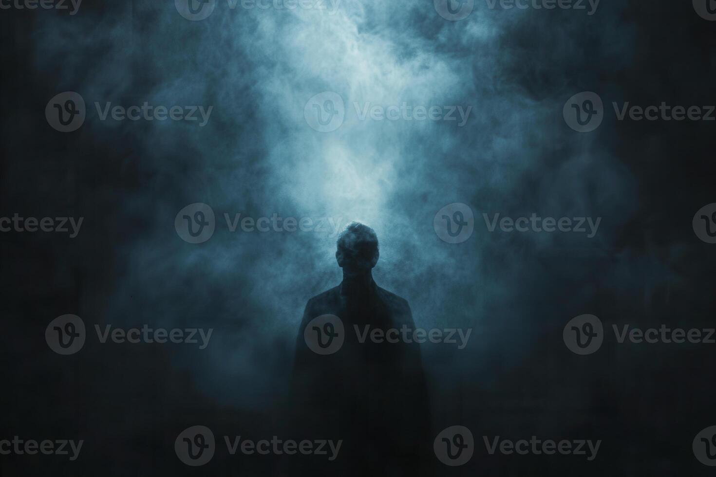 Mysterious figure standing in smoke-filled atmosphere during nighttime in an eerie, atmospheric setting photo