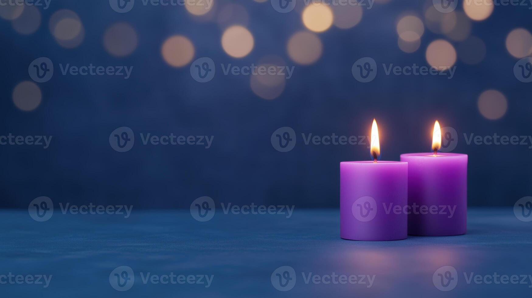 Two purple candles on a blue background with bokeh photo