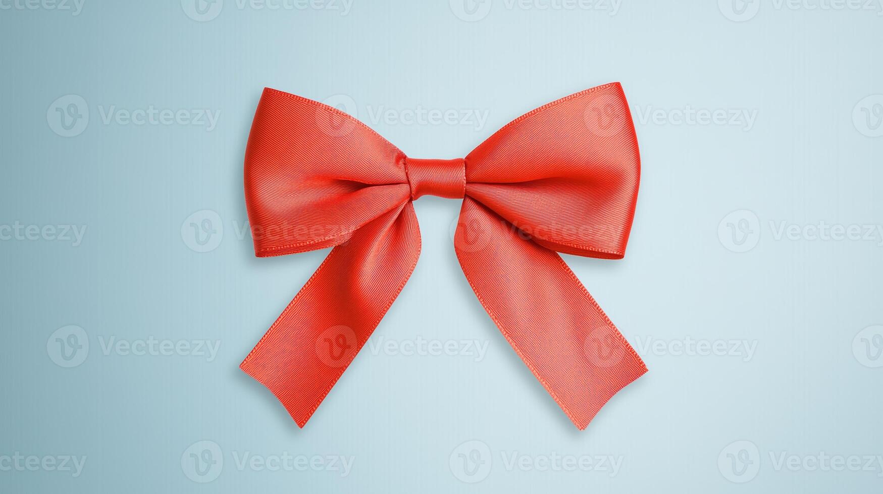 Elegant Red Satin Ribbon Bow Isolated on Light Blue Background for Gift Wrapping, Celebrations, Holidays, and Invitations in a Classic and Minimalist Style photo