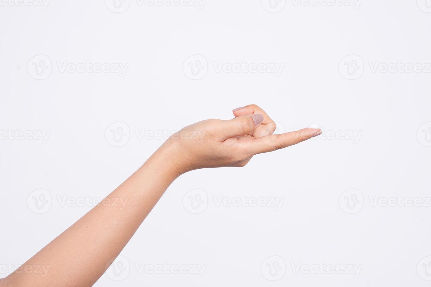 A drop of thick white hand cream on the finger of a woman's hand. Groomed hands on a light background photo