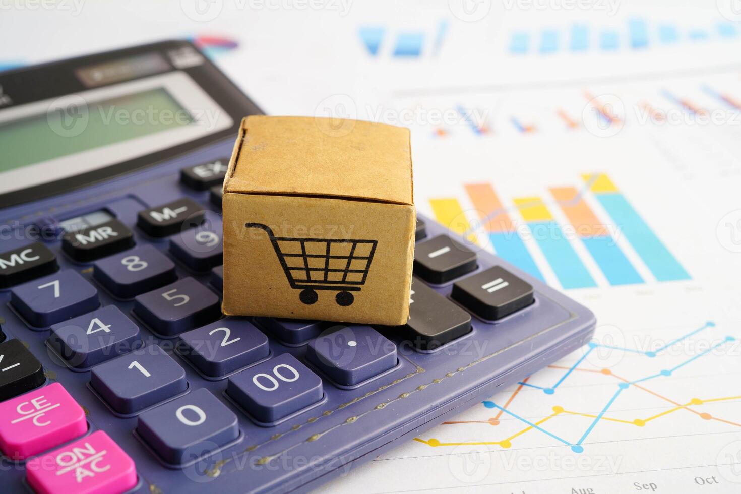 Online shopping, Shopping cart box on calculator, import export, finance commerce. photo