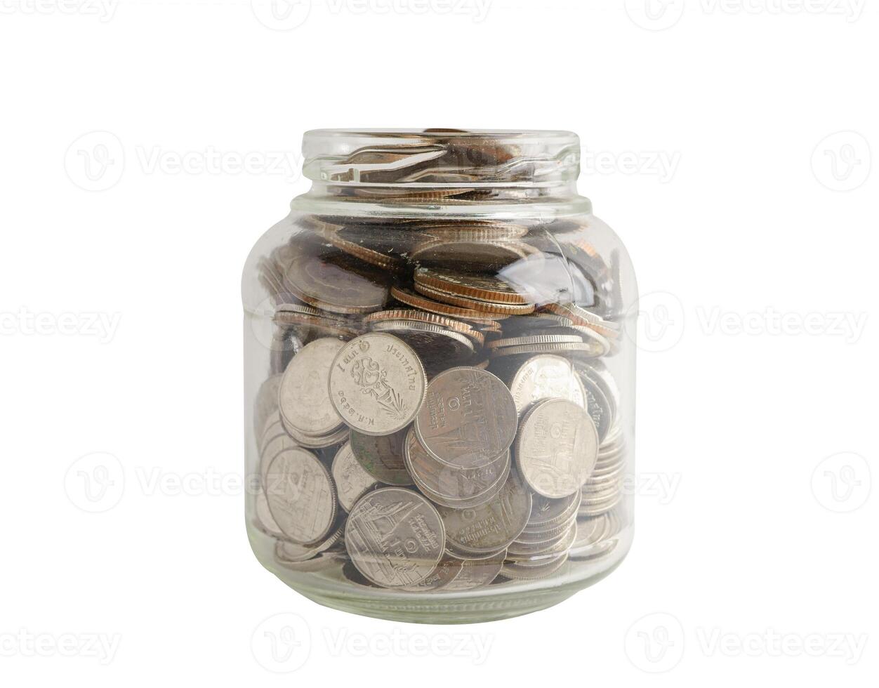 Coins in glass bottle isolated on white background with clipping path, banking finance economy. photo