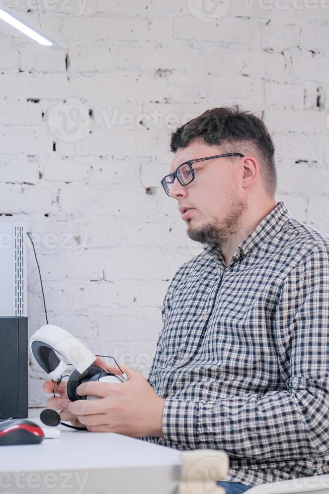Man Working from Home on Laptop Computer in Stylish Loft Apartment photo