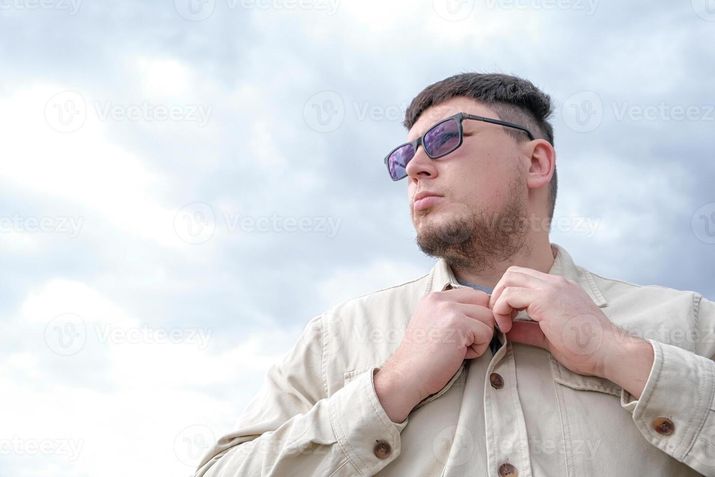 young man enjoying autumn days breathing fresh air photo