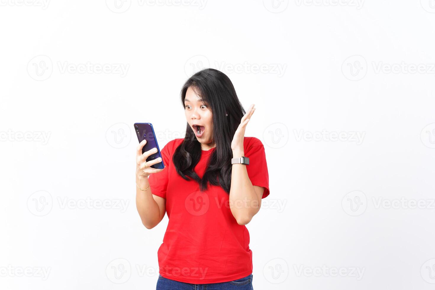 Shocking Wow face looking at smartphone and holding smartphone Of Beautiful Asian Woman wearing red shirt Isolated On White Background photo