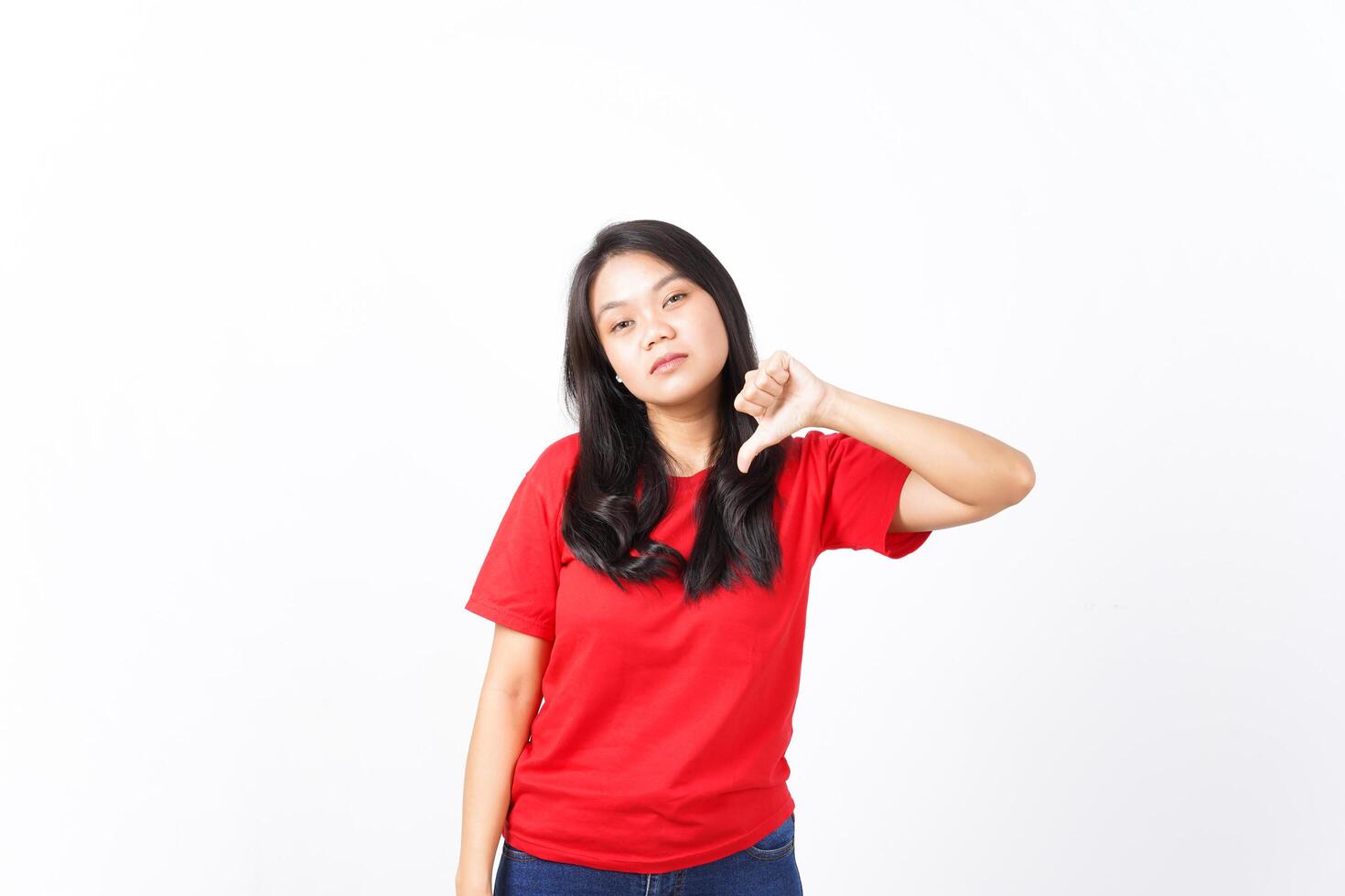 Showing Thumb Down, Dislike Concept Of Beautiful Asian Woman Wearing Red Shirt Isolated On White Background photo