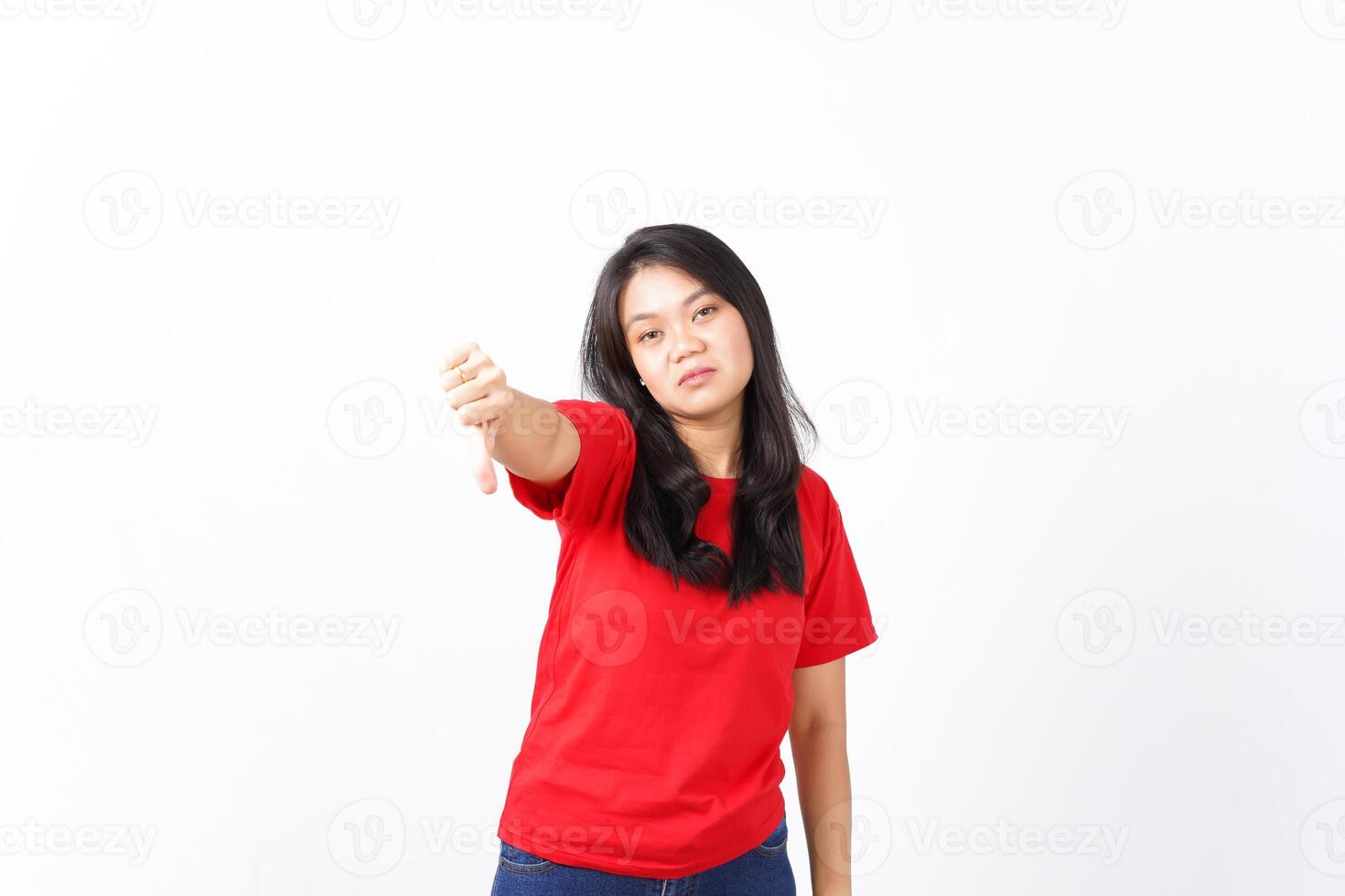 Showing Thumb Down, Dislike Concept Of Beautiful Asian Woman Wearing Red Shirt Isolated On White Background photo