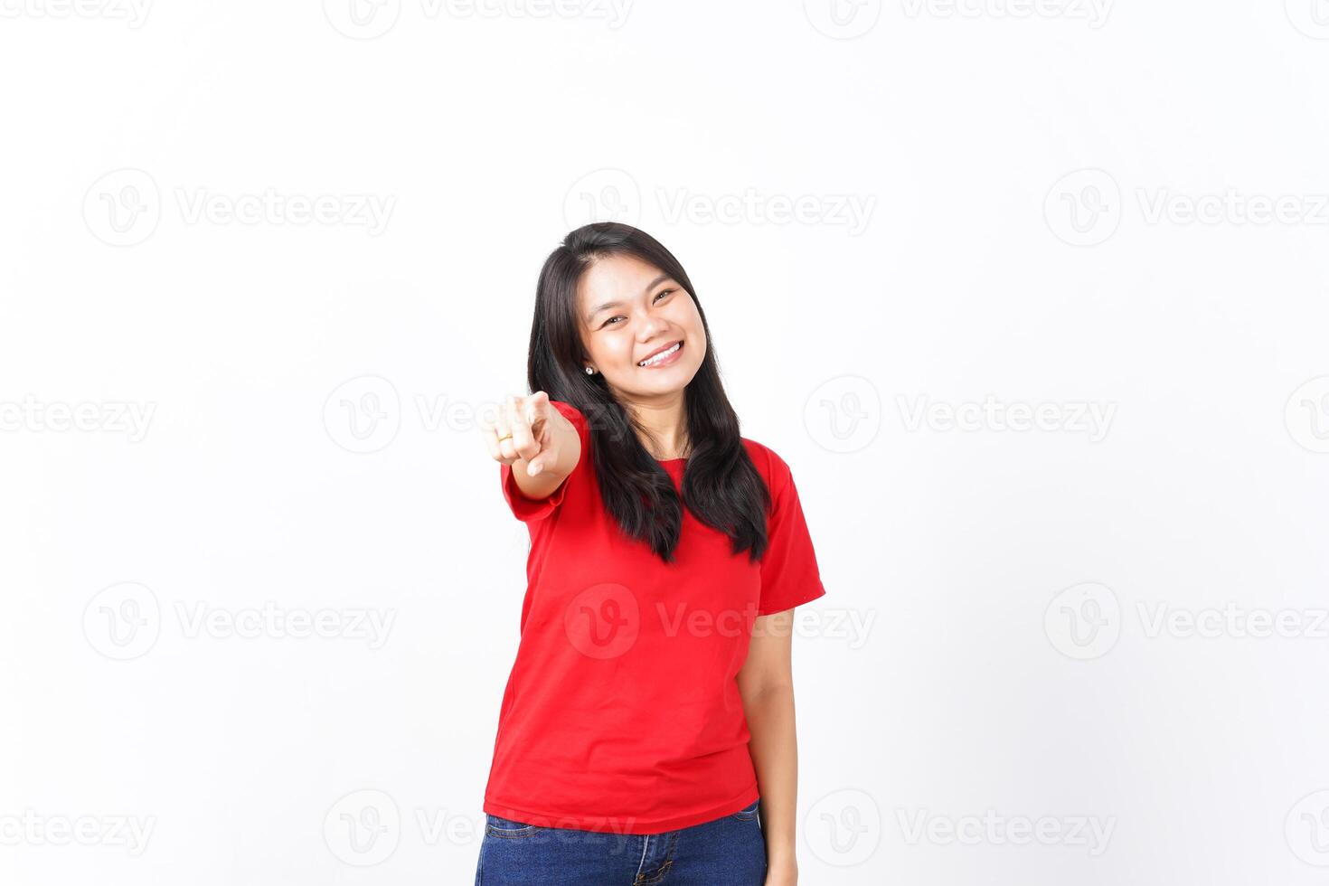 Smiling and Pointing at camera or you, want you gesture Of Beautiful Asian Woman wearing red shirt Isolated On White Background photo