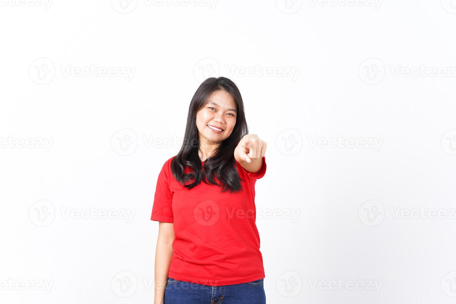 Smiling and Pointing at camera or you, want you gesture Of Beautiful Asian Woman wearing red shirt Isolated On White Background photo