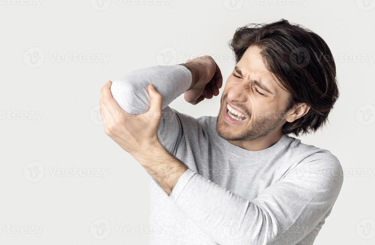 Inflammation in elbow. Man screams at pain, free space photo