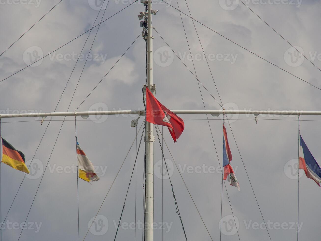 A group of flags on a pole photo