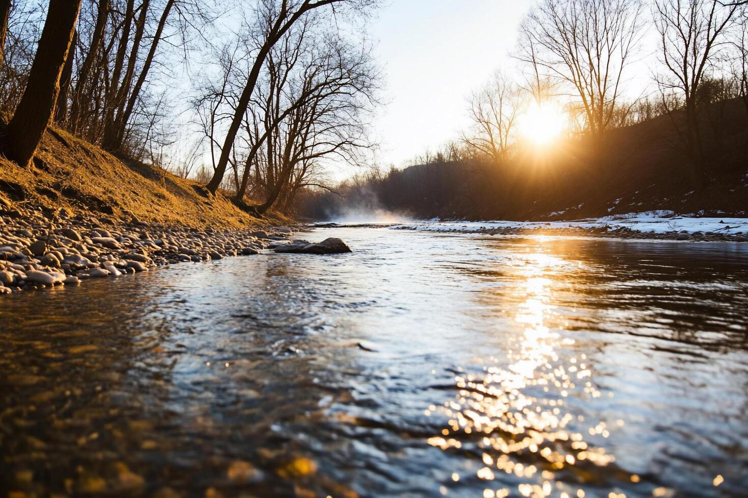 A river running through a snowy forest at sunset photo