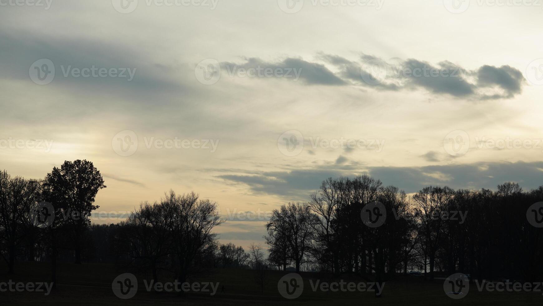 The beautiful sunset sky view with the colorful clouds and warm lights in the sky photo