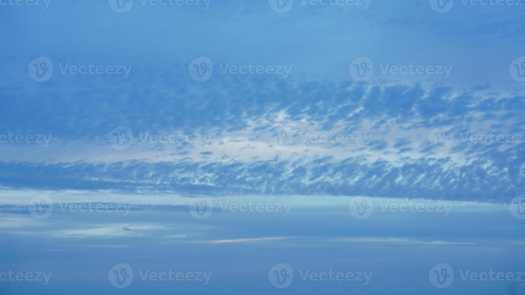 The beautiful sunset sky view with the colorful clouds and warm lights in the sky photo