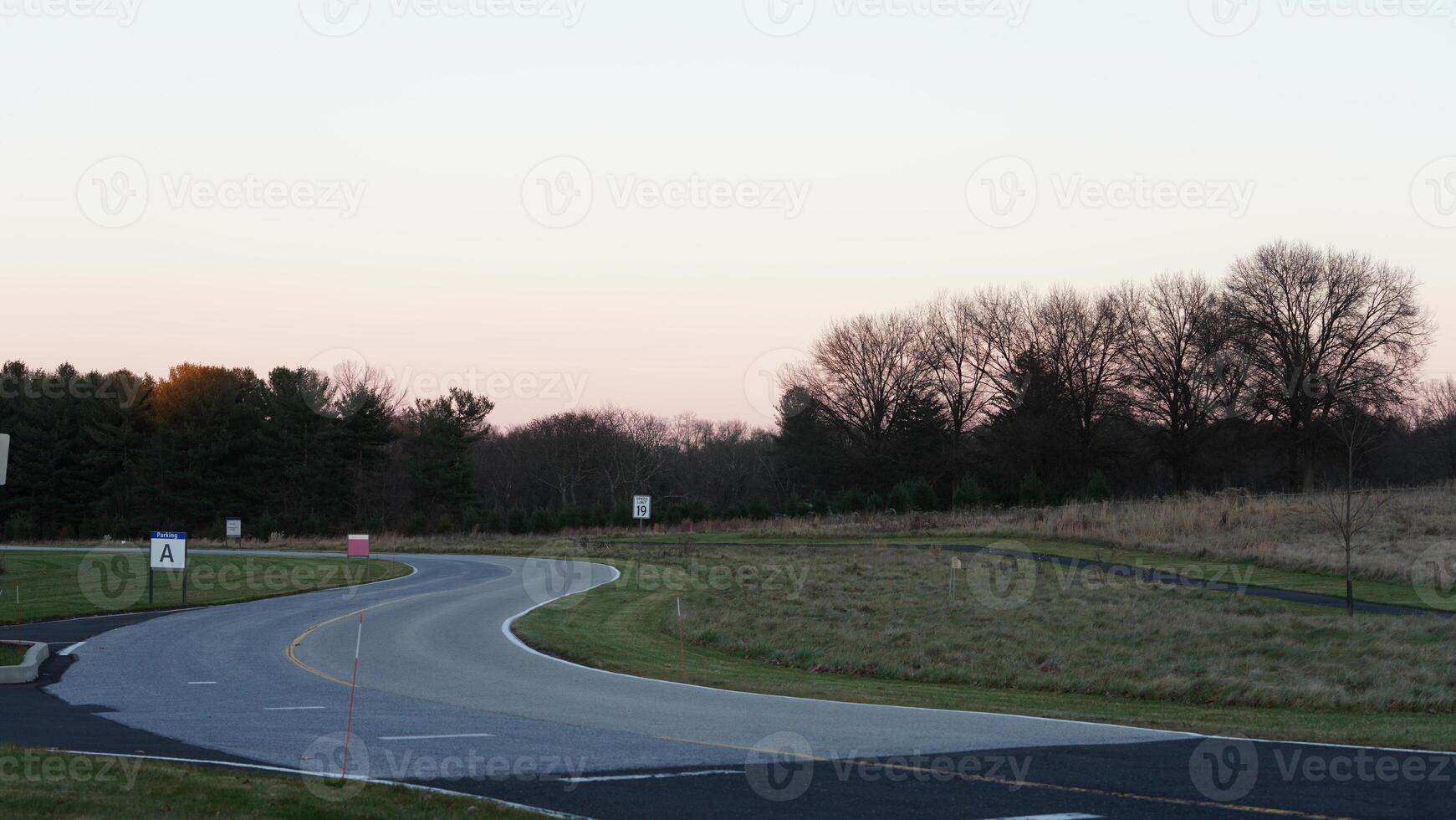 The forest view with the narrow country road across them in winter photo
