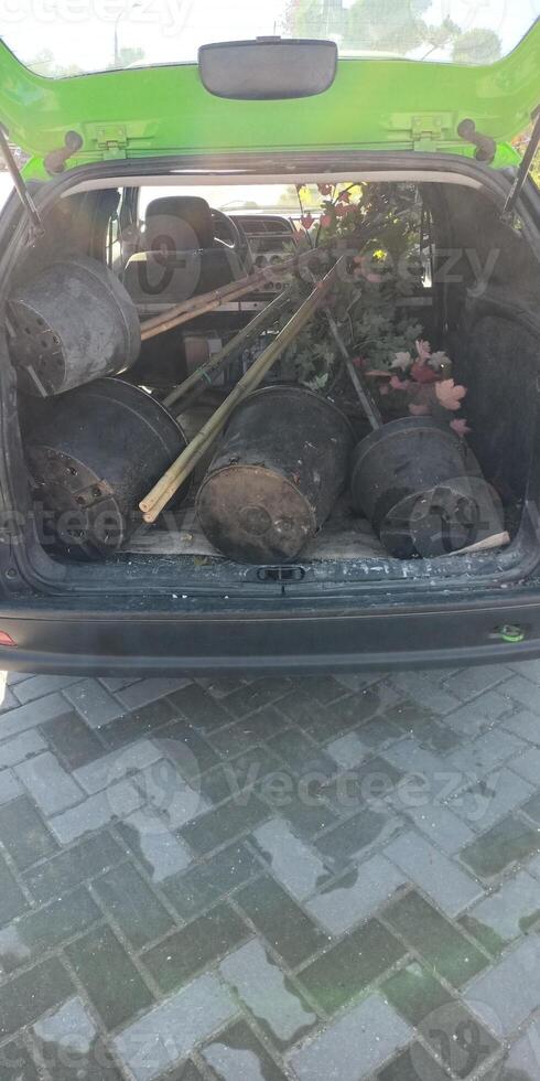 The Car Trunk is Fully Loaded with a Variety of Different Garden Supplies and Tools photo