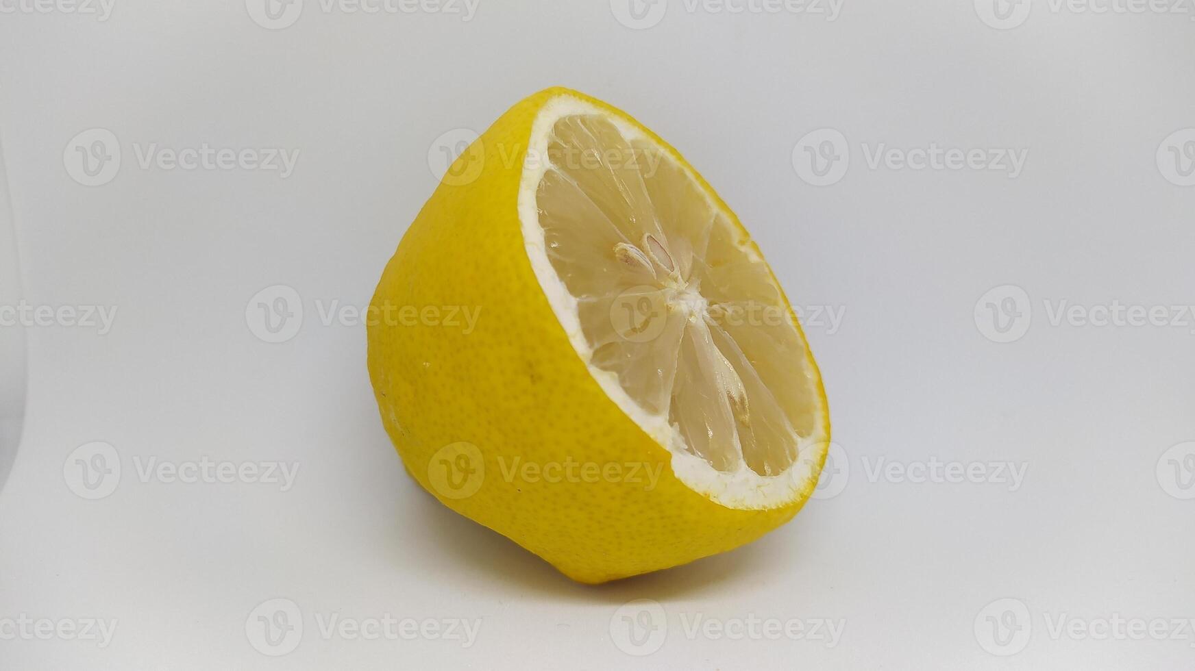 A Fresh Lemon Half set against a pristine White Background, exuding vibrant energy and appeal photo