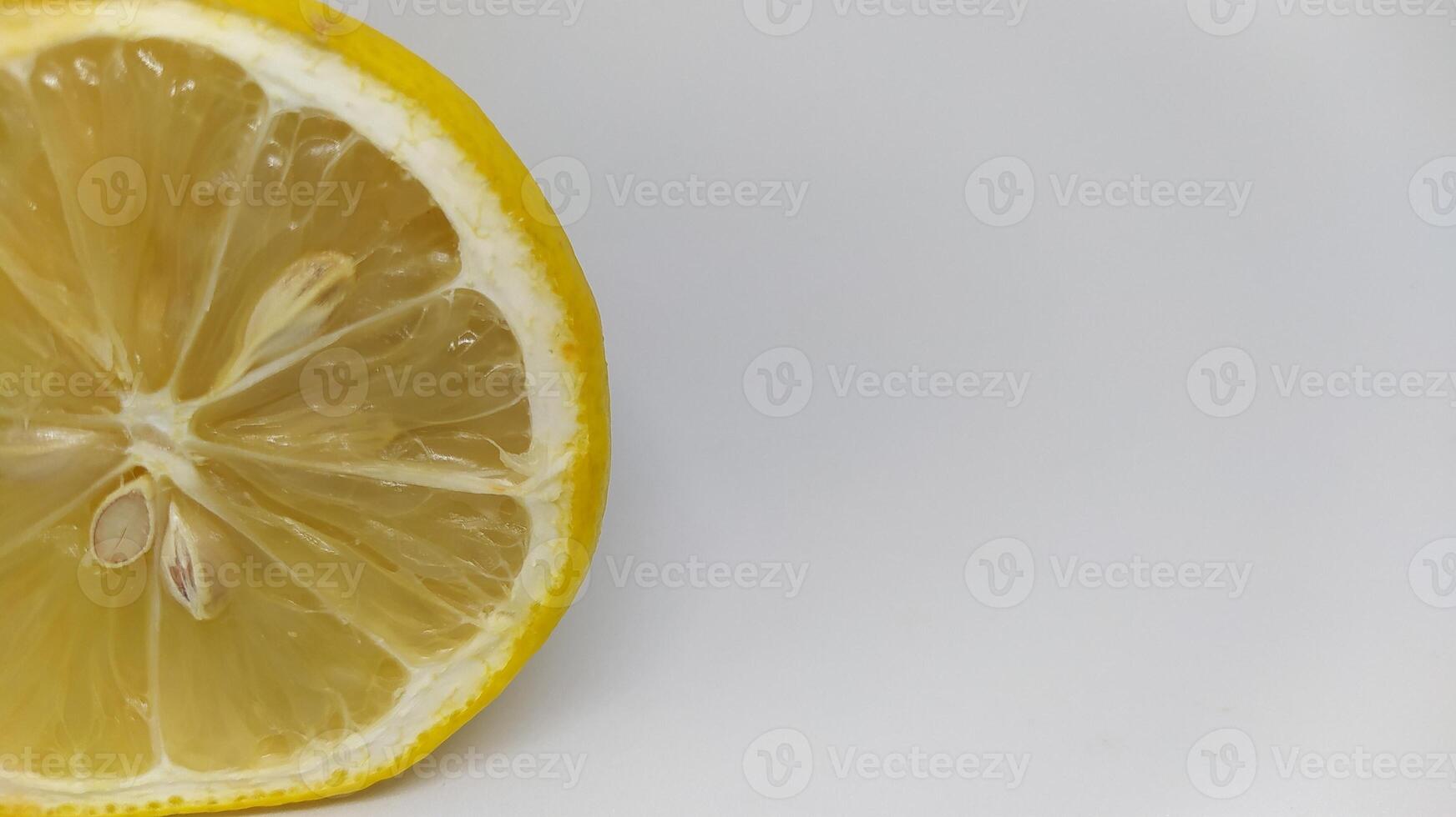 A Fresh Lemon Slice is beautifully displayed on a pristine White Background for presentation photo