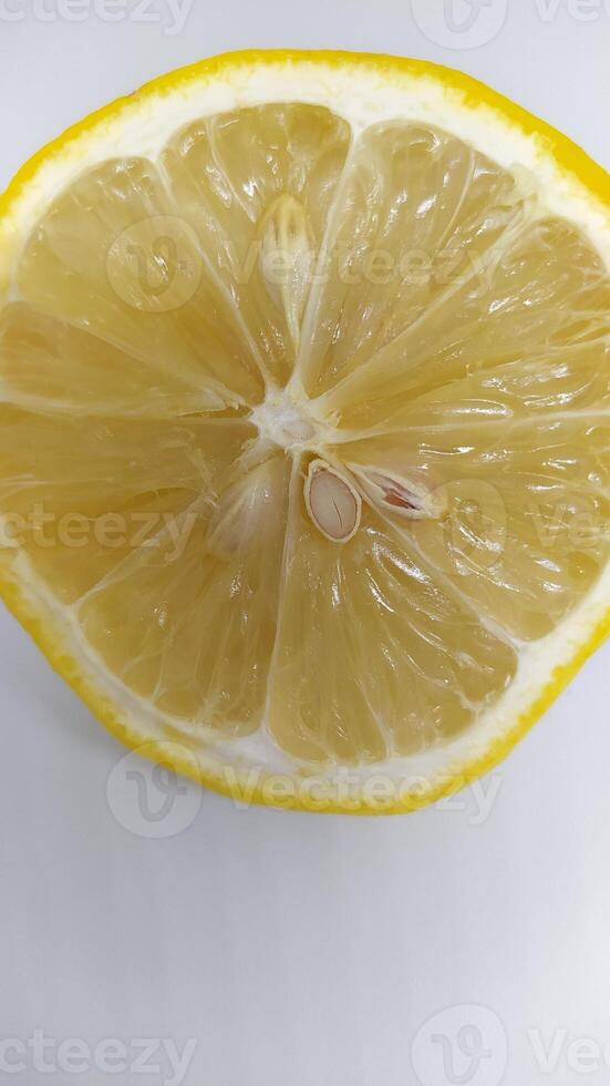 A Freshly Cut Lemon Half Displaying Its Visible Seeds and Exuding a Juicy Texture photo