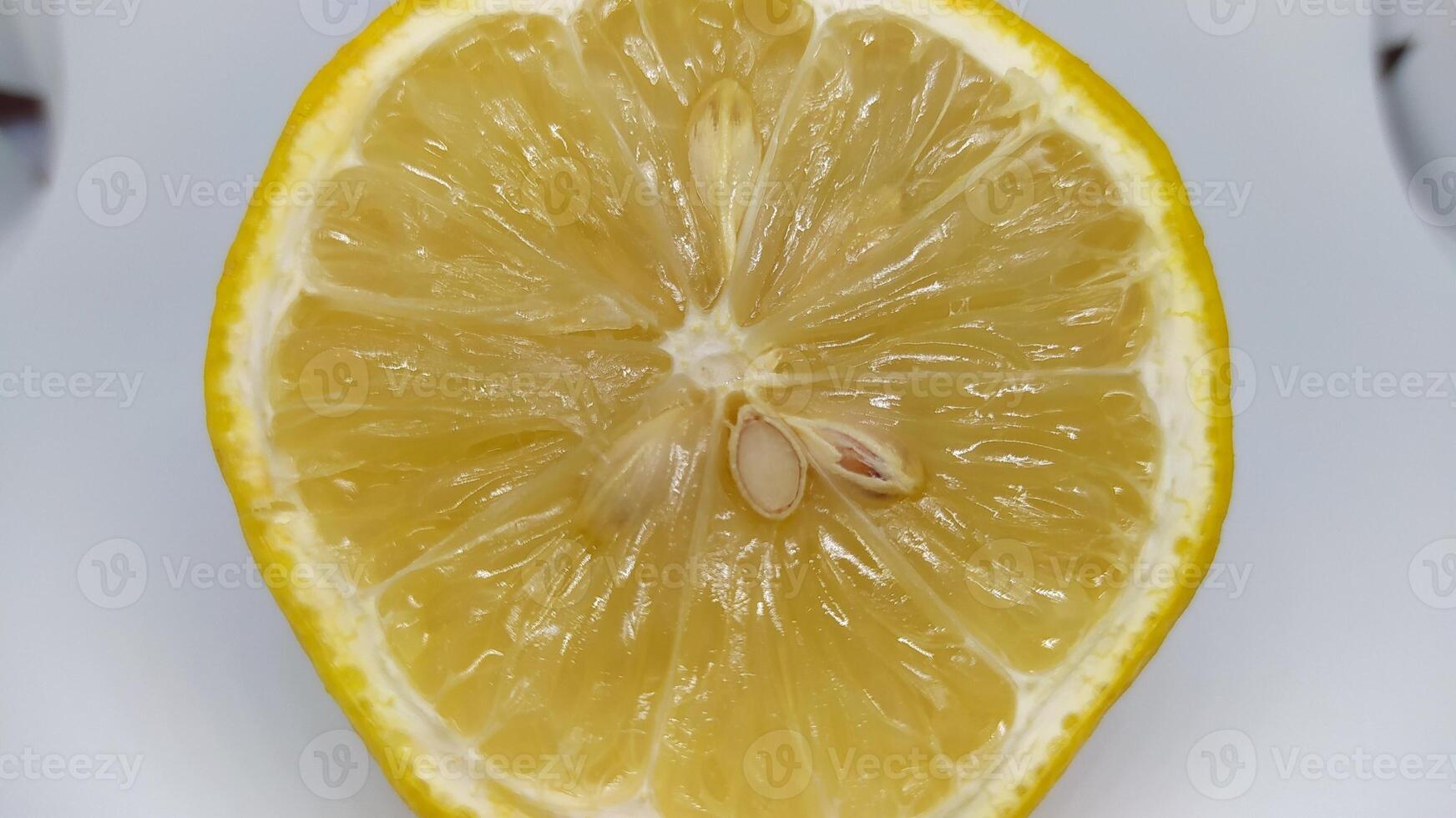 Bright and Freshly Cut Half of a Lemon, Complete with Seeds and Succulent Ripe Flesh Inside photo