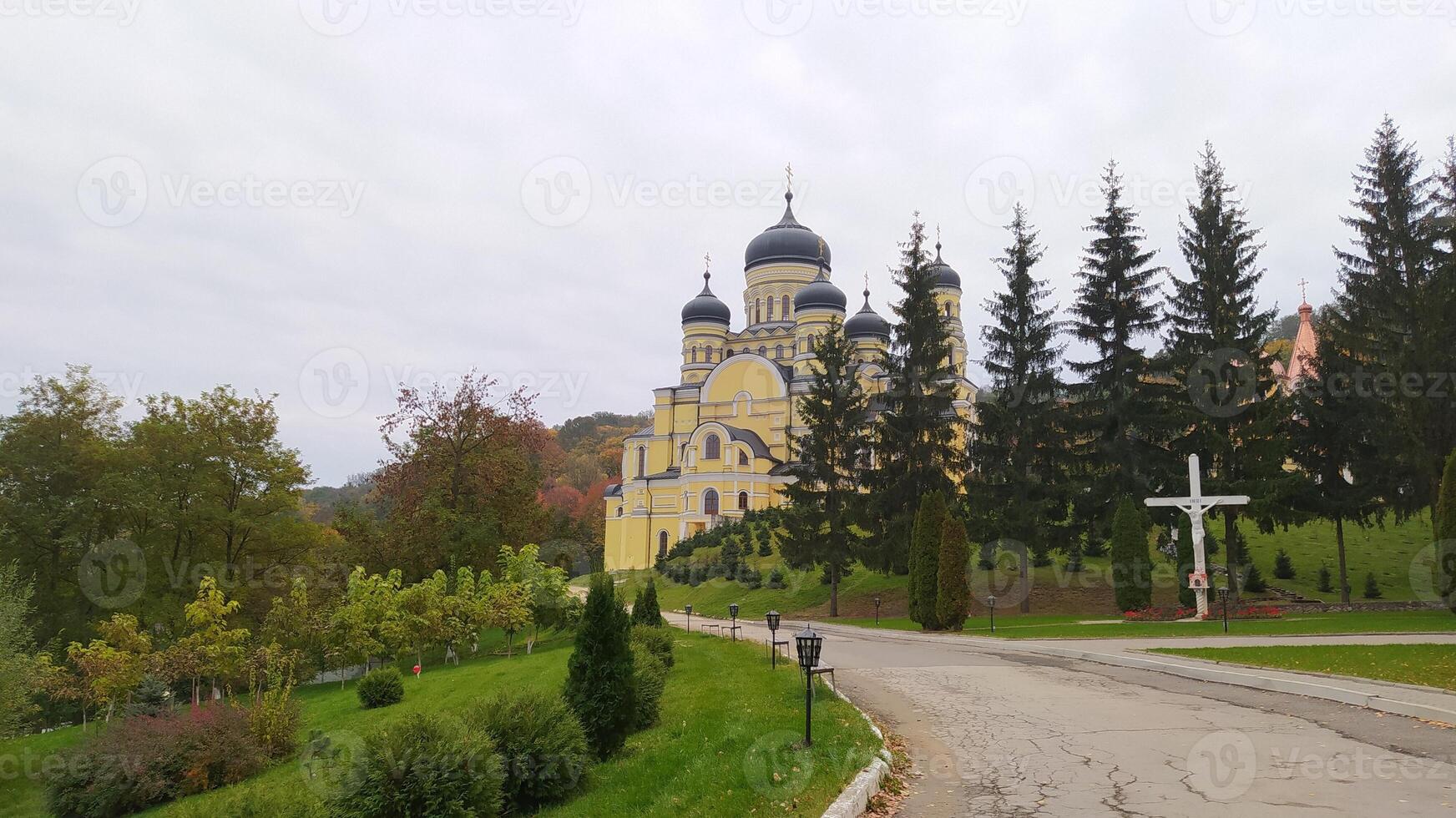 A Serene and Picturesque Landscape Featuring a Majestic Church Surrounded by Lush Greenery photo