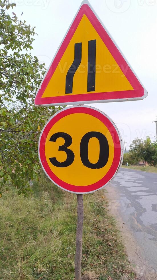 Warning Signs for Curvy Roads Indicating Speed Limit for Safer Driving Conditions Ahead photo
