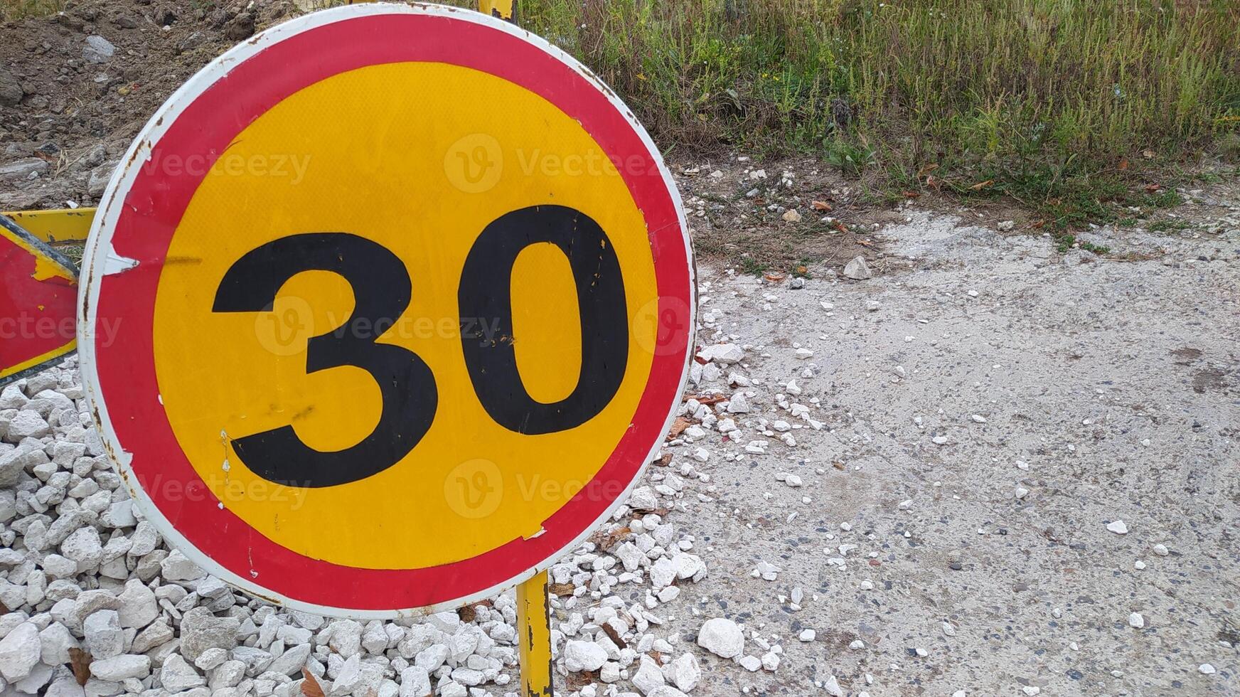 A Speed Limit Sign prominently displayed at the roadside to inform drivers and cyclists photo