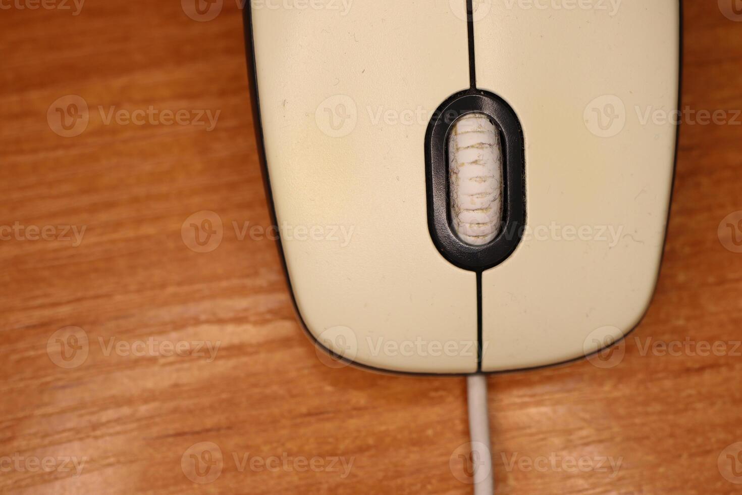 An UpClose View of a Vintage Computer Mouse Resting on a Wooden Surface for Aesthetic Appeal photo