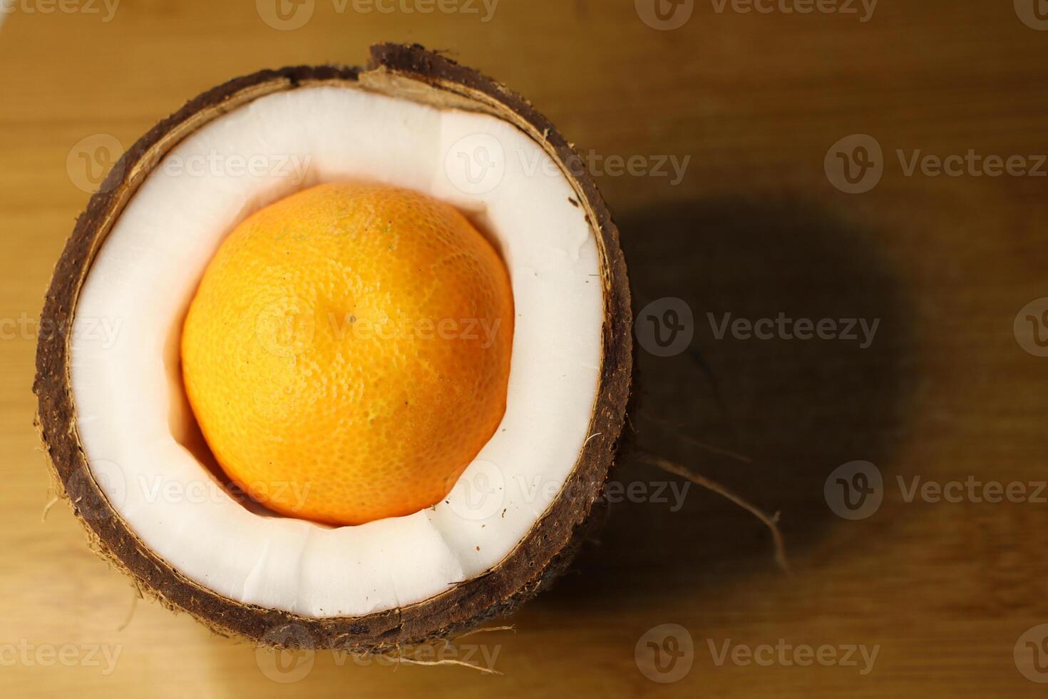 A Unique Fantasy of an Orange Displayed Inside a Coconut Shell An Artistic Still Life photo
