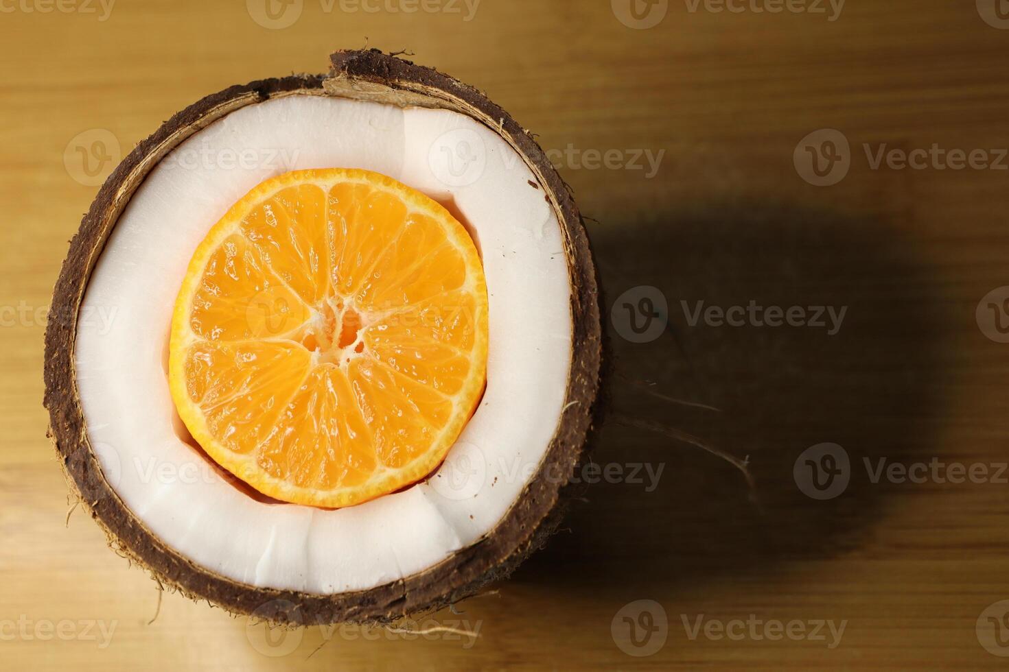 A beautifully arranged cross section of a coconut and orange showcasing a unique presentation style photo