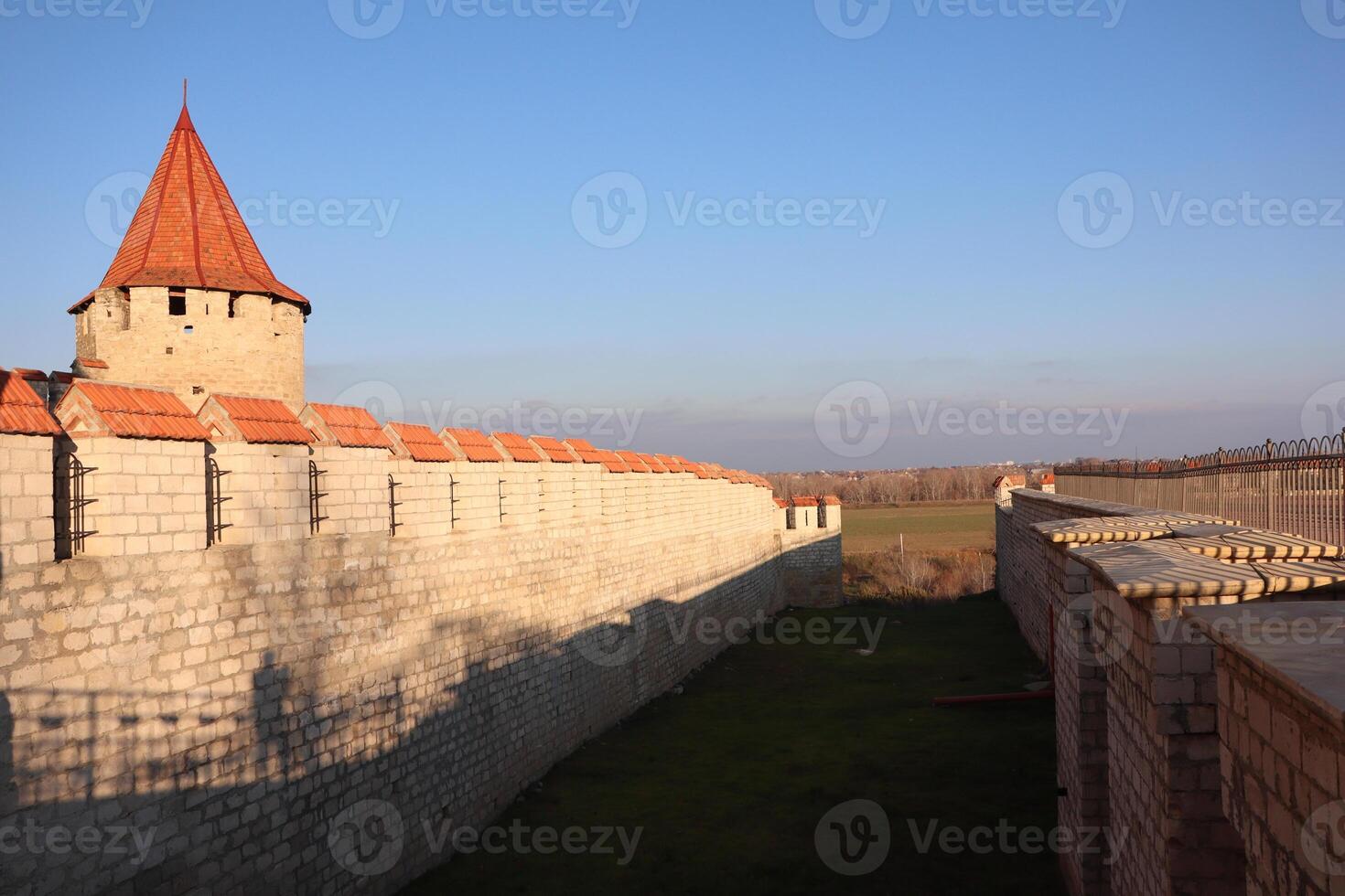 A historic fortress stands tall with its tower against a clear blue sky, showcasing beauty photo