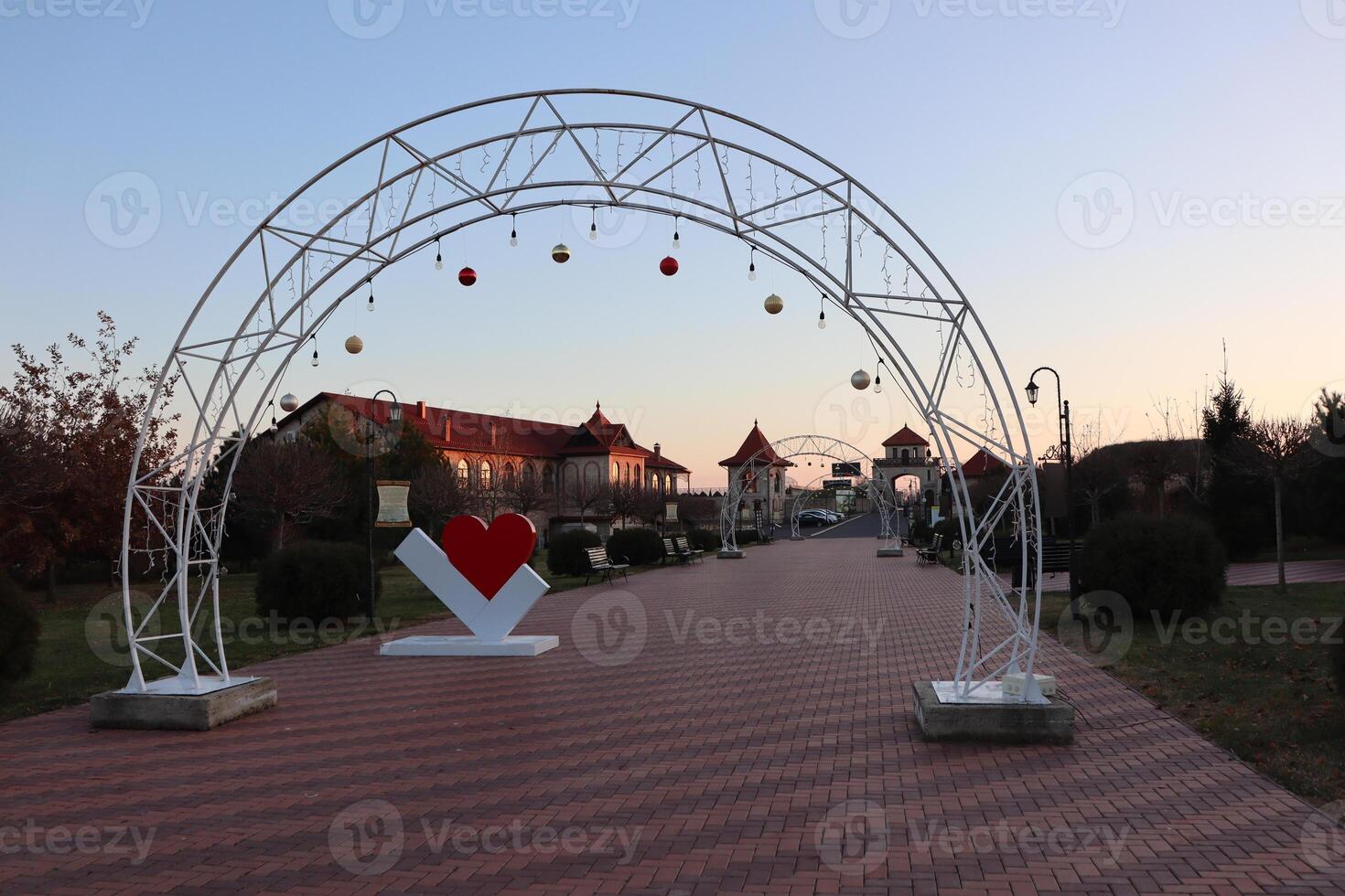 Charming Decorative Archway Set in a Beautiful Scenic Park During a Lovely Sunset photo