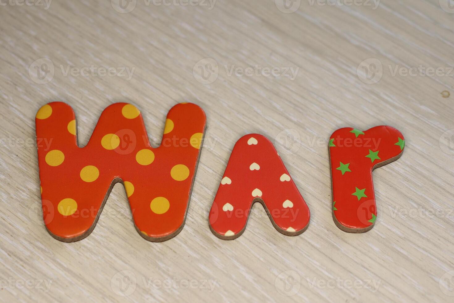 Colorful and vibrant Letter Magnets creatively Spelling out the word WAR on a Light Background photo