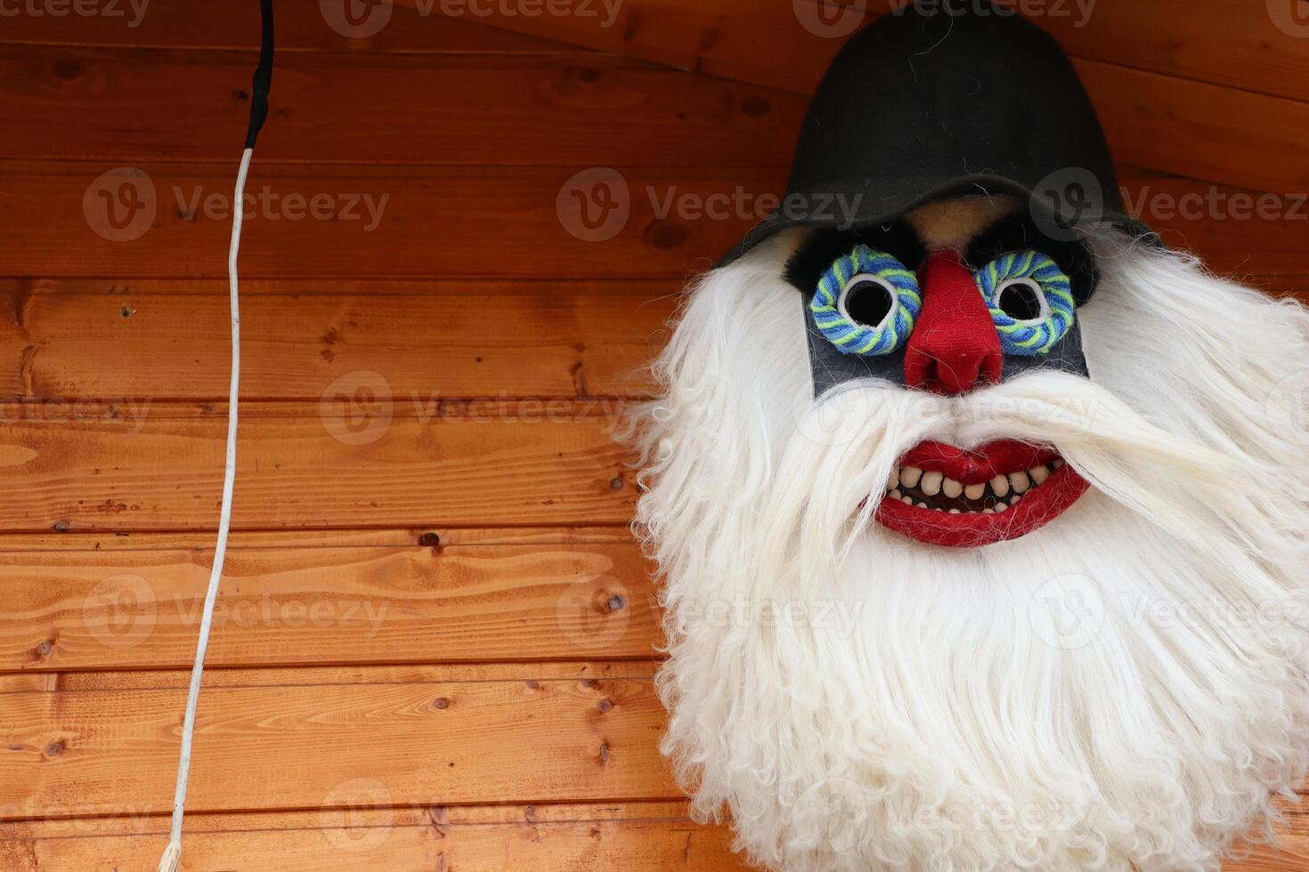A Vibrant Colorful Mask Featuring a Distinctive White Beard and Unusual, Striking Eyes photo